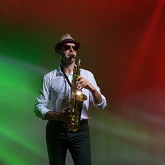 Fototapeta na wymiar Man playing saxophone on stage