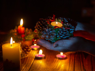  burning candle on the palms of an elderly woman.
