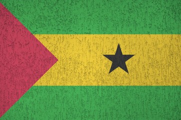 Sao Tome and Principe flag depicted in bright paint colors on old relief plastering wall. Textured...