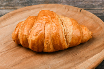 croissant closeup. Fresh french croissant. To on a wooden background. View from above. Morning breakfast with a croissant. French breakfast