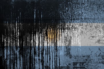 Argentina flag depicted in paint colors on old and dirty oil barrel wall closeup. Textured banner on rough background