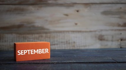 september 22nd. Day 22 of month, calendar on a color cubes. hand puts the day of the month on the name of the month on a wooden background autumn, day of the year concept