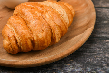 croissant closeup. Fresh french croissant. To on a wooden background. View from above. Morning breakfast with a croissant. French breakfast
