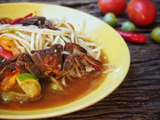 Papaya salad Thai food on wood background