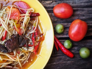Papaya salad Thai food on wood background