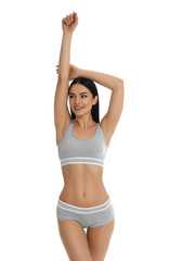 Beautiful young woman in grey sportive underwear isolated on white