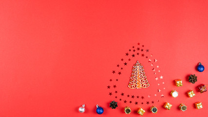 Concept of Christmas and New Year holiday and sale. Flat lay of wooden Christmas tree, confetti stars, cone and balls.