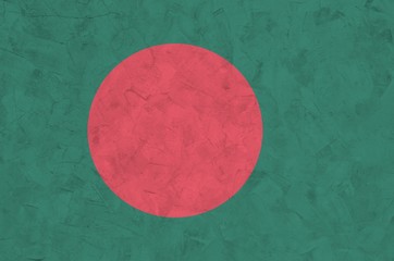 Bangladesh flag depicted in bright paint colors on old relief plastering wall. Textured banner on...
