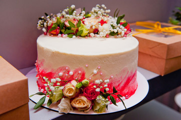 Cake for a wedding decorated with beautiful fresh flowers