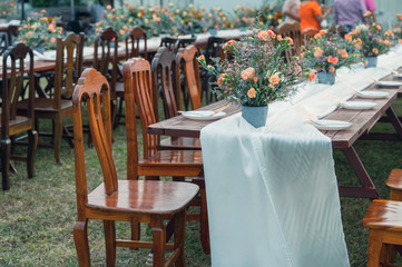 Rustic wedding style, Wooden dining table with flowers decoration and tableware