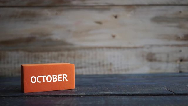 october 30th. Day 30 of month, calendar on a color cubes. hand puts the day of the month on the name of the month on a wooden background autumn, day of the year concept