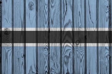 Botswana flag depicted in bright paint colors on old wooden wall. Textured banner on rough...
