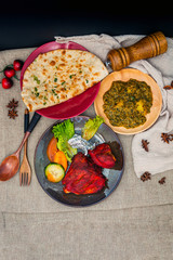 Traditional Indian food chicken tandoori and Tikka with garlic naan