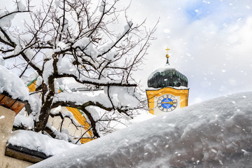 Roof of old building covered with thick snow drift layer after heavy snowfall blizzard and austrian...