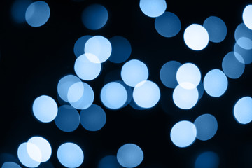 Abstract blue bokeh lights glow on black. Holiday concept