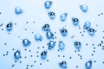 Holiday Christmas blue flat lay with shiny balls and confetti