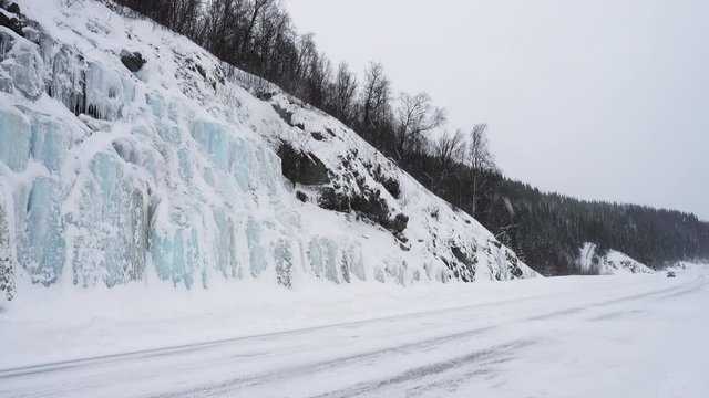 FINNSNES, TROMS, NORWAY, MARCH 03 2019: cars and trucks on a snow covered slippery road during the hard snowfall