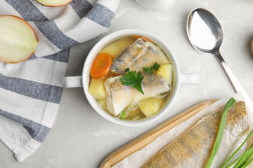Delicious fish soup served on light table, flat lay