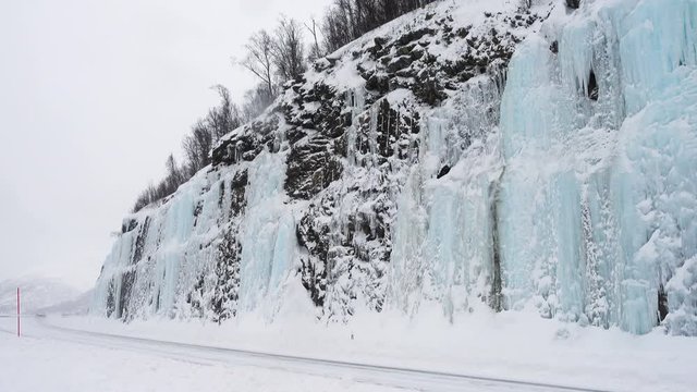 FINNSNES, TROMS, NORWAY, MARCH 03 2019: cars and trucks on a snow covered slippery road during the hard snowfall