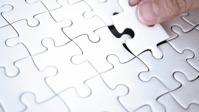 last piece of jigsaw filling by hand, step of success concept