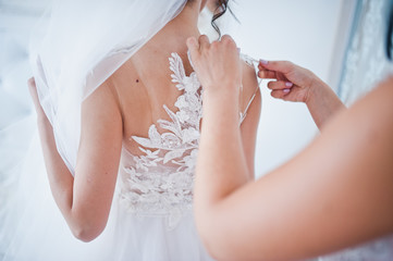 Morning of the bride preparation. Young and handsome bride at wedding day.
