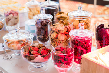 Shortbread cookies in glassware and other sweets on the buffet table during the coffee break