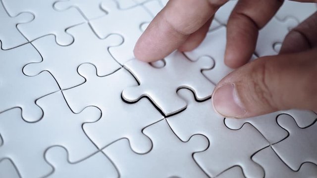 last piece of jigsaw filling by hand, step of success concept