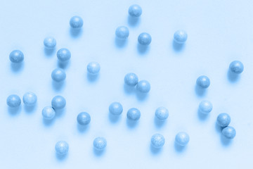 Classic blue color of the year 2020 Creative flat lay cosmetics background, blush balls and cosmetic brushes on neo-mint color background.