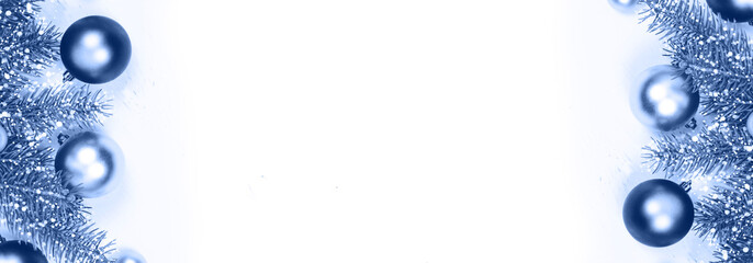 Christmas classic silver and blue decoration baubles and fir tree branches on white banner background of many wooden planks with copy space for text. Rustic holiday and new year concept. Color of 2020