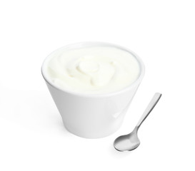 Tasty organic yogurt in bowl and spoon isolated on white