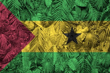 Sao Tome and Principe flag depicted on many leafs of monstera palm trees. Trendy fashionable...