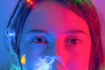 Portrait of a woman in neon lights. Concept of party, celebration, making a wish or new year...