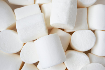 Soft white marshmallows texture, close-up. Heap of sweet food, top view. Christmas candy background