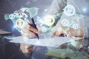 Hand taking notes in notepad. Forex chart holograms in front. Concept of research. Multi exposure