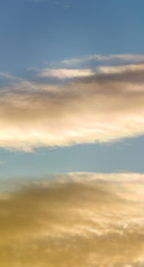 Obraz premium Fantastic clouds at sunrise, vertical panorama