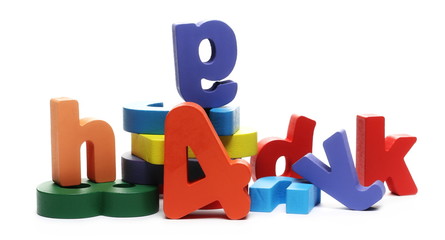 Colorful wooden alphabet, spelling and number blocks, isolated on white background
