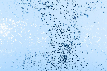 Blue sparkles on cold grey background. Main color trend for 2020 year.