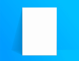 White poster mockup standing on the floor near blue color wall. Blank Canvas Mockup for design