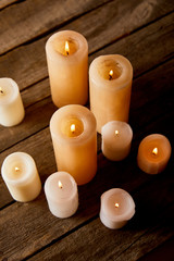 Fototapeta na wymiar burning candles on wooden table on christmas eve