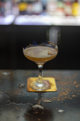 The bartender is lighting a cocktail, a cocktail is lit in a bar