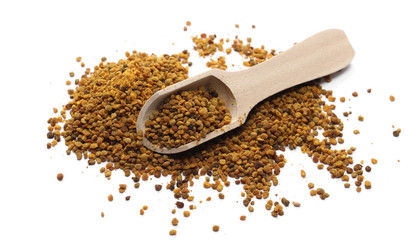 Propolis, pollen pile with wooden spoon, isolated on white background