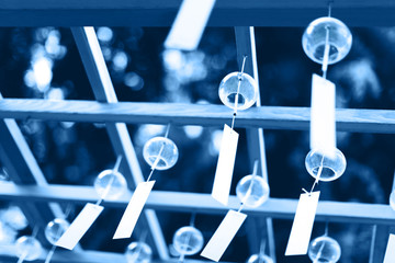Many glass wind chimes in trendy blue toning. Main color trend for 2020 year.
