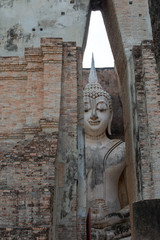 Fototapeta na wymiar View of Buddha statue in Sukhothai temple, Thailand 2019