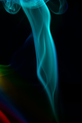 Fototapeta premium multicolored smoke photo against black background