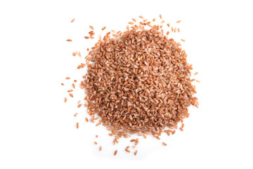 Heap of unpolished brown rice isolated on white background. Top view, close up.
