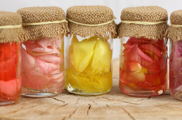 Massage oils, with multicolor roses petals in oil