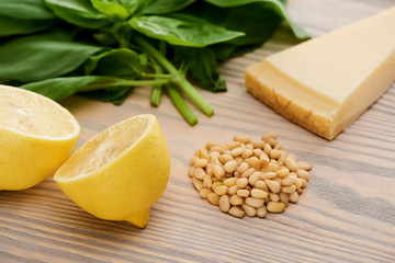 close up view of pesto sauce raw ingredients on wooden table