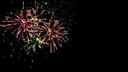 Fototapeta premium Colorful traditional fireworks in night sky, isolated on black