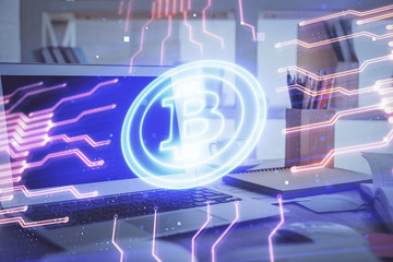 Multi exposure of blockchain theme hologram and table with computer background. Concept of bitcoin crypto currency.