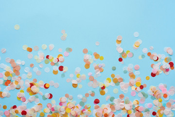 Top view of multicolored confetti on blue - obrazy, fototapety, plakaty
